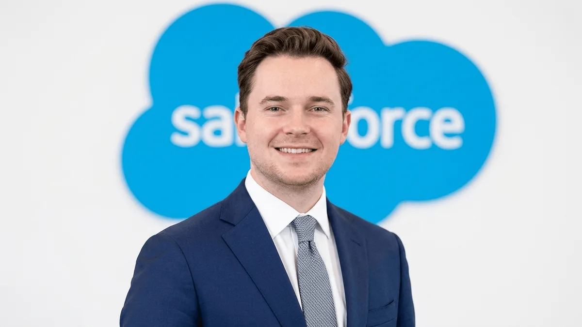 Ben Grime standing in front of a Salesforce logo